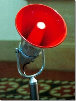 "Electronic red megaphone on stand" by Adamantios @ Wikimedia